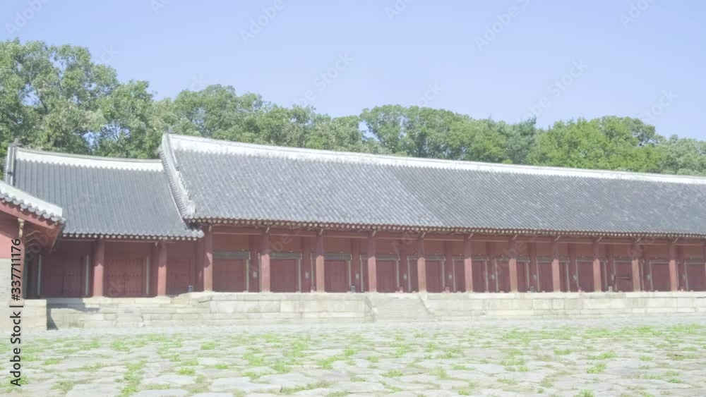 Camera pan right to reveal empty courtyard and length of Confucian Jongmyo Shrine angled view from corner in Seoul, South Korea Camera pan right to reveal empty courtyard and length of Confucian Jongmyo Shrine angled view from corner in Seoul, South Korea