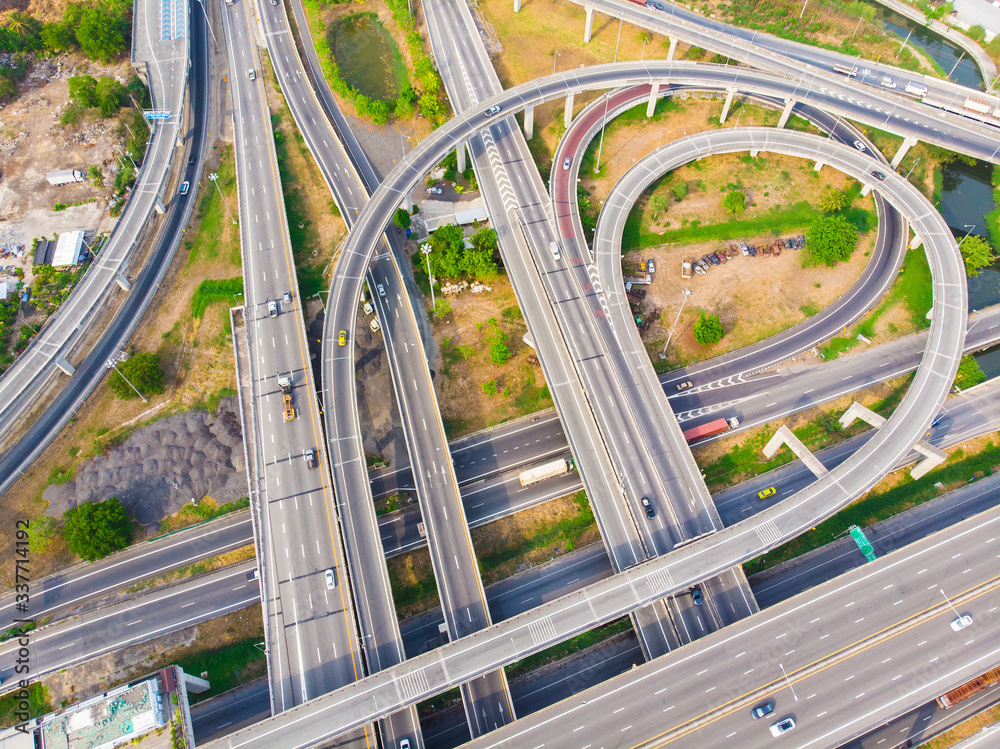 Fototapeta premium Aerial view elevated city road junction and interchange overpass at day light