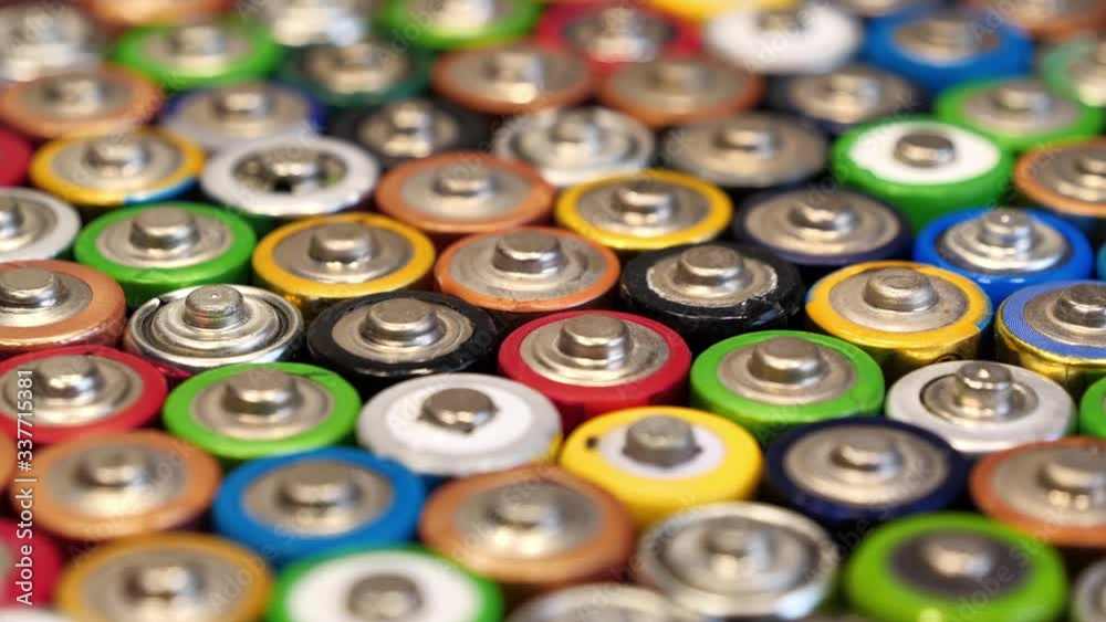 Closeup of a lot of multicolored used AA batteries Closeup of a lot of multicolored used AA batteries