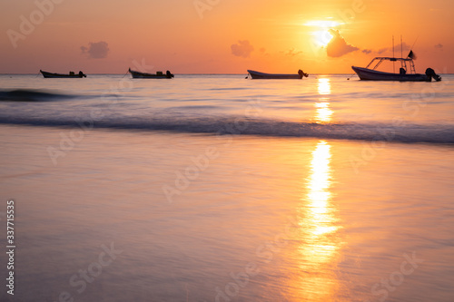 Sunrise in Caribbean sea, Tulum beach, boat line, Mexico 