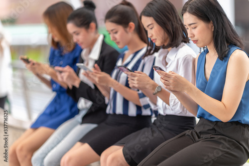 Group Asia women using smartphone and checking information on phone