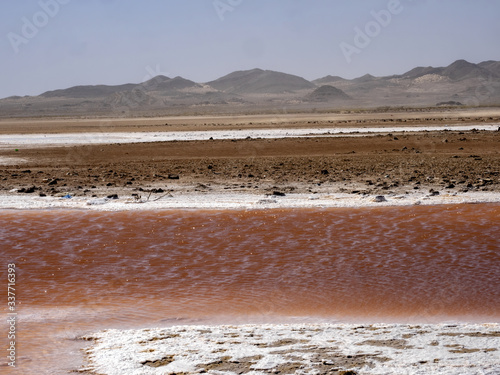 A small salt lake with brown bacteria in central Oman photo