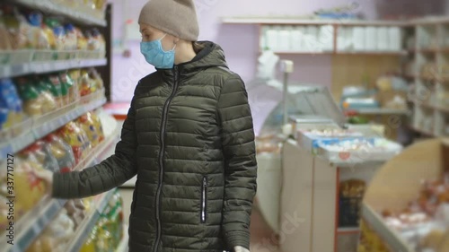 woman in protective mask chooses pasta photo