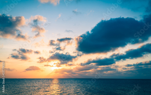 sunset over the sea in the evening with colorful sunlight and dark clouds, dusk sky. 