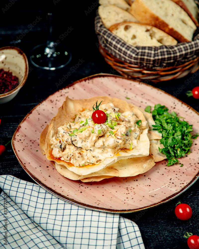 creamy chicken and mushroom dish served in crusty flatbread creamy chicken and mushroom dish served in crusty flatbread