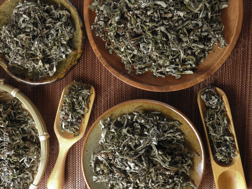 Top view of dry mugwort on bamboo mat. Be used to ward off evil spirits and to drive away mosquitoes during the Dragon Boat Festival in Taiwan.  Chinese herbal medicine. With copy space.