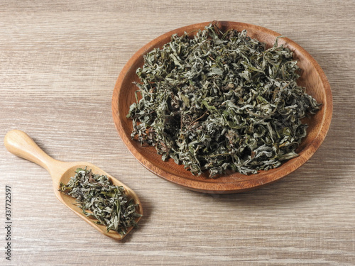 High angel view of dry mugwort on wooden plate and spoon. Chinese herbal medicine. During the Dragon Boat Festival, which is used to ward off evil spirits and to drive away mosquitoes. With copy space