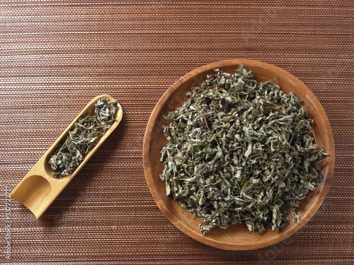Top view of dry mugwort on wooden plate and spoon.  During the Dragon Boat Festival, which is used to ward off evil spirits and to drive away mosquitoes. Chinese herbal medicine. With copy space