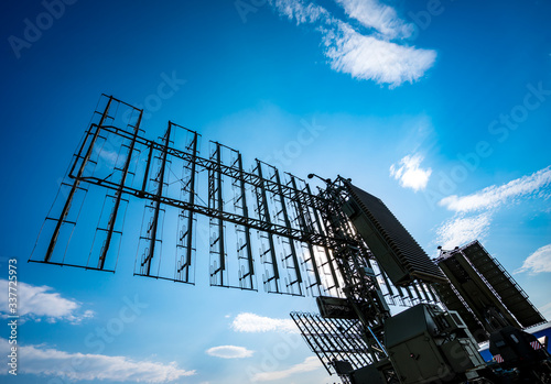 Air defense radars of military mobile antiaircraft systems, modern army industry on background beautiful clouds and blue sky