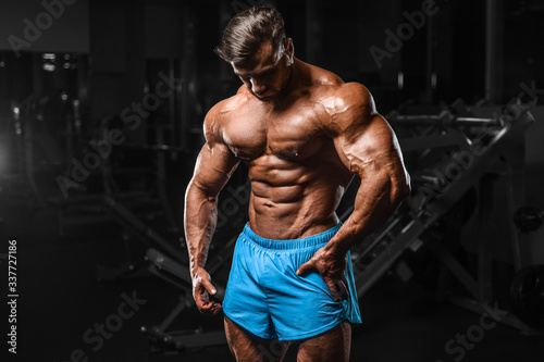 Bodybuilder strong man pumping up abs muscles © antondotsenko
