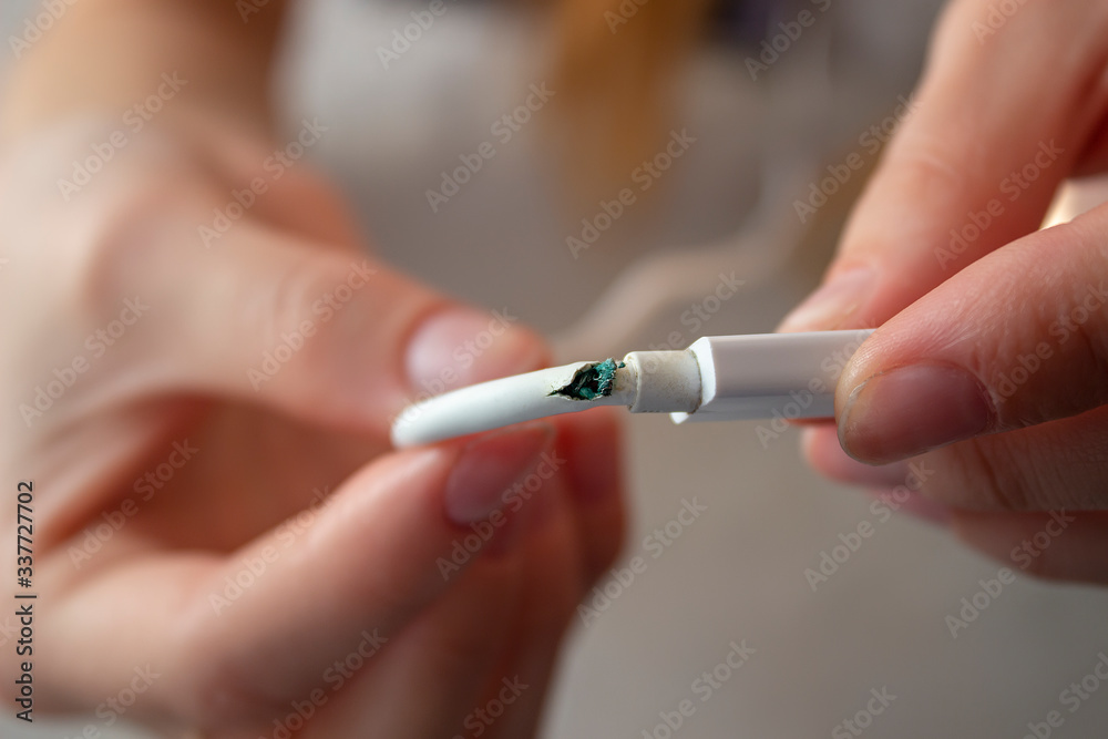 Broken phone charging wire. a person is holding a damaged wire. Broken phone charging wire. a person is holding a damaged wire.