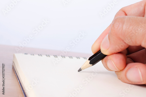 Pencil pointing to notepad with macro close up for business backgrounds