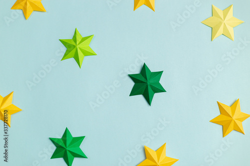 Colored paper stars over blue background