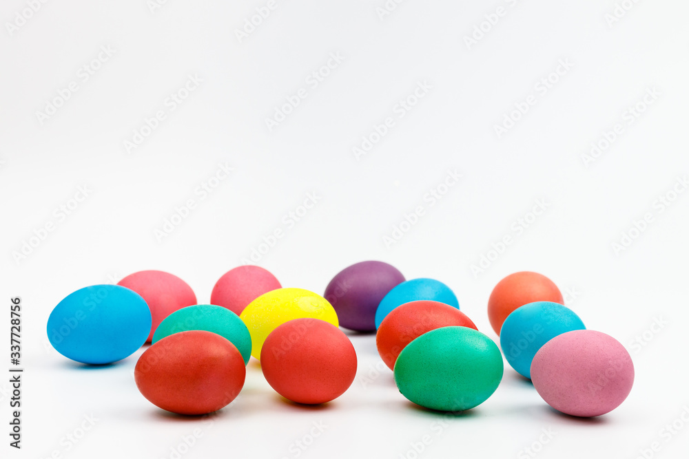 Easter multicolor eggs isolated on a white background. Rainbow. Copy space. Flat lay. Side view. Easter multicolor eggs isolated on a white background. Rainbow. Copy space. Flat lay. Side view.