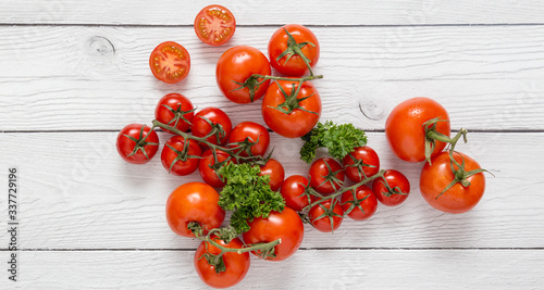Copy space with red fresh tomatoes at white wood board background