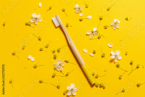 natural bamboo toothbrush on a yellow background. eco friendly.