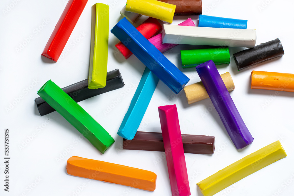 multi-colored plasticine cubes lie a bunch on a white background. isolate. children's creativity multi-colored plasticine cubes lie a bunch on a white background. isolate. children's creativity