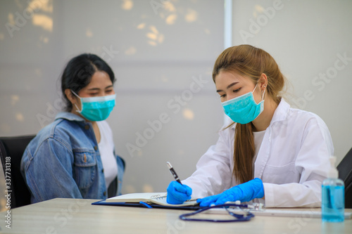 Female Asian pediatrician hold stethoscope exam girl patient visit doctor in the clinic