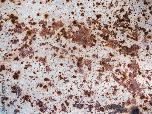 Worn rusty metal surface with cracking texture background.