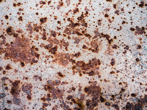Worn rusty metal surface with cracking texture background.