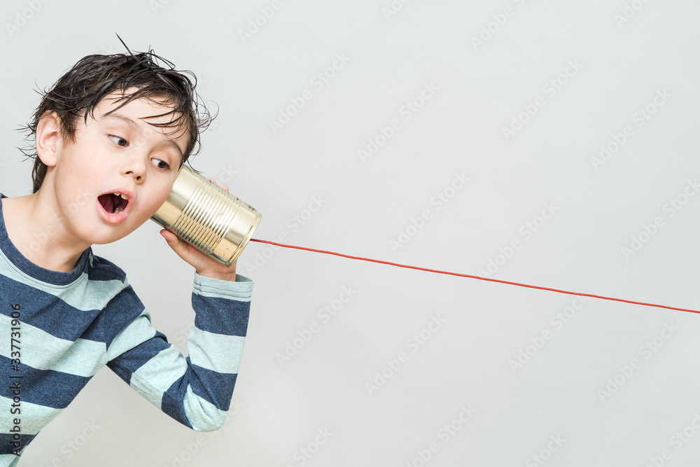 Little boy holding a can with a cord - obrazy, fototapety, plakaty 