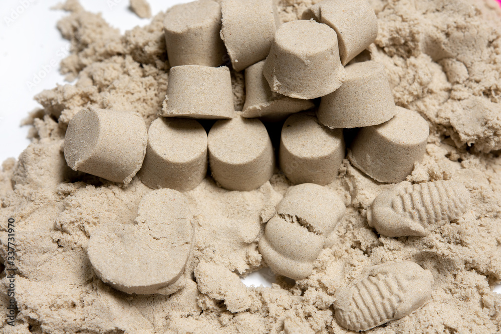 Obraz premium many small towers of kinetic sand. play with a child.