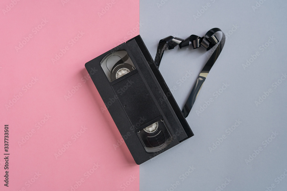 Top view An old cassette with the tape coming out. Top view An old cassette with the tape coming out.