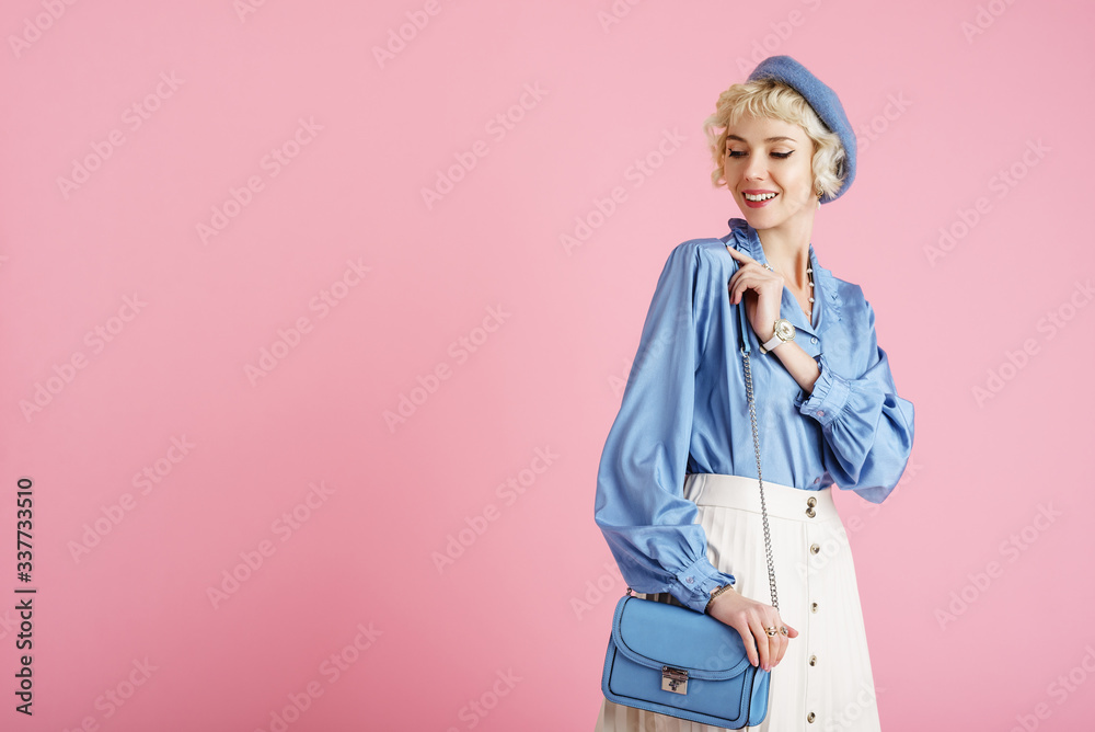 Fashion portrait of elegant happy smiling woman wearing trendy spring outfit: blue blouse, beret, white pleated skirt, with stylish faux leather shoulder bag. Copy, empty space for text Fashion portrait of elegant happy smiling woman wearing trendy spring outfit: blue blouse, beret, white pleated skirt, with stylish faux leather shoulder bag. Copy, empty space for text