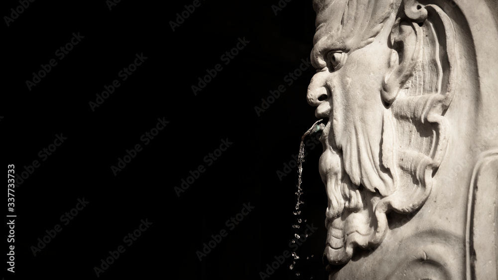 Close up of a fountain in Florence, Tuscany, Italy with black copy space