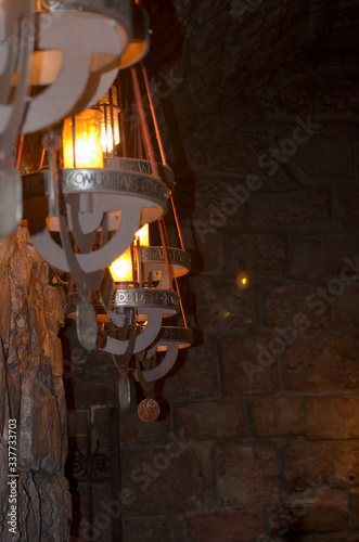 Old-style icon lamps in a church on a stone wall