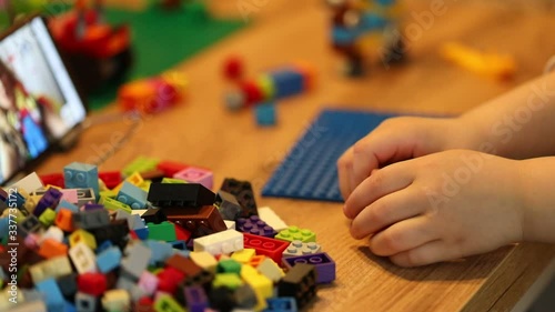 Little girl online learning and creating at home. Quarantine and Social distancing concept.