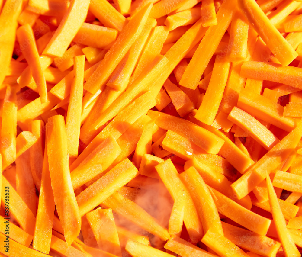 Fresh orange carrots sliced as a background. Fresh orange carrots sliced as a background.