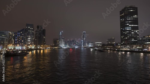 Wide shot of boats on the River Thames looking upstream from Lambeth Bridge as traffic flies past on Albert Embankment and Millbank. photo