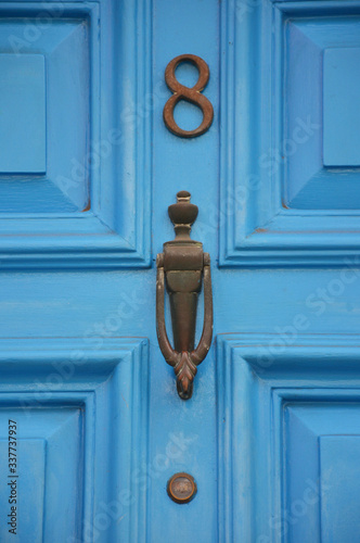 Old metal door handle of a wooden door