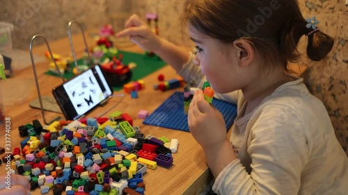 Little girl online learning and creating at home. Quarantine and Social distancing concept.