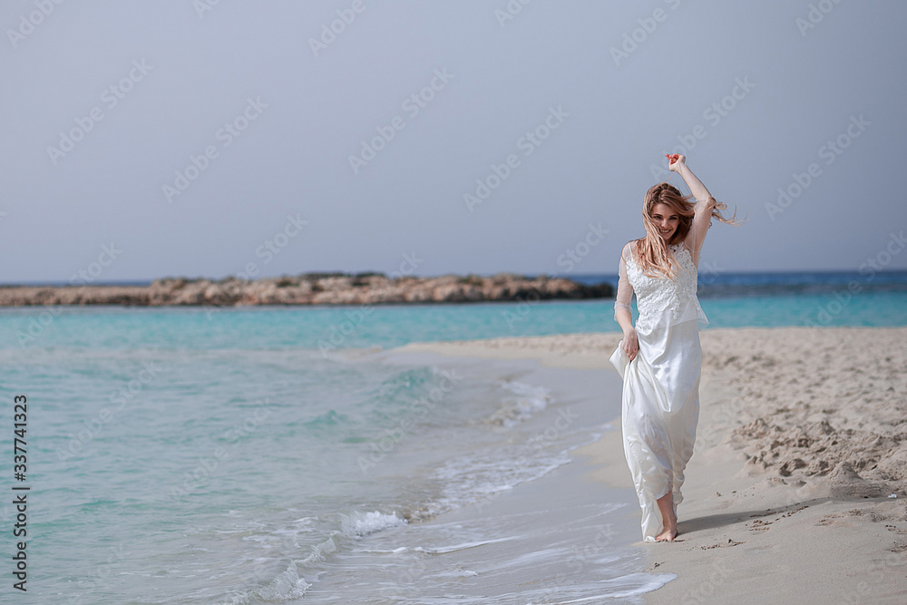 Woman happy pretty wear amazing dress at tropical wedding ceremony..Bride luxury white wedding dress sunny day tropic nature background on of palm trees. Tropic wedding. Woman happy pretty wear amazing dress at tropical wedding ceremony..Bride luxury white wedding dress sunny day tropic nature background on of palm trees. Tropic wedding.