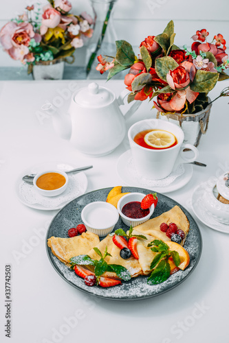 pancakes with strawberries, raspberries and jam, breakfast, healthy food on white background