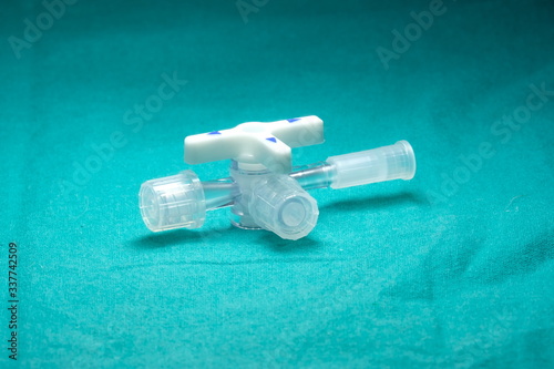 Three way stopcock with luer slip For medical purposes On a green cloth