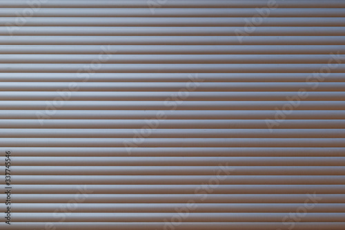 Fototapeta Naklejka Na Ścianę i Meble -  White metal with horizontal linear stripe pattern of rolling shutter door.