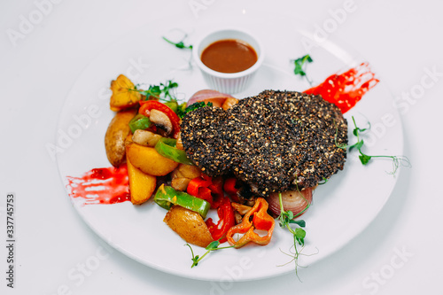pepper steak with grilled vegetables with sauce on an isolated white background