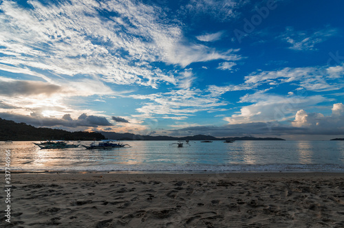 Beautiful sunset in the beach of Port Barton in a cloudy sky evening