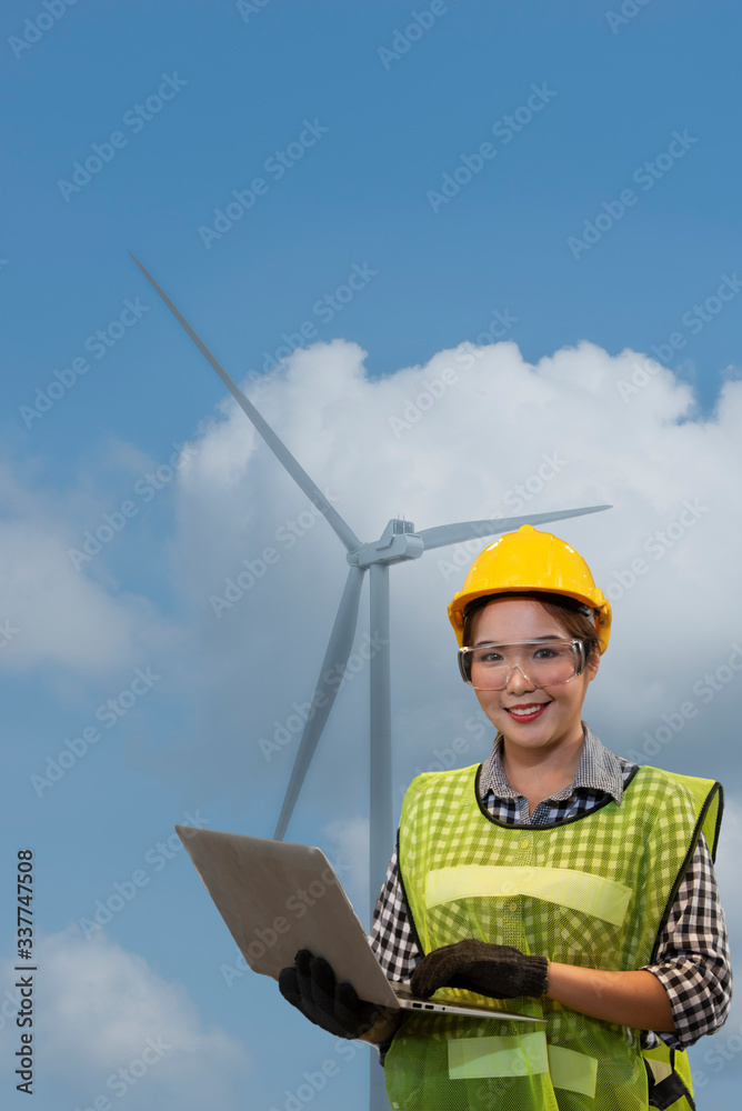 engineer with laptop on wind turbine background engineer with laptop on wind turbine background