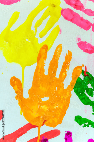 Colorful painted hand prints on white background