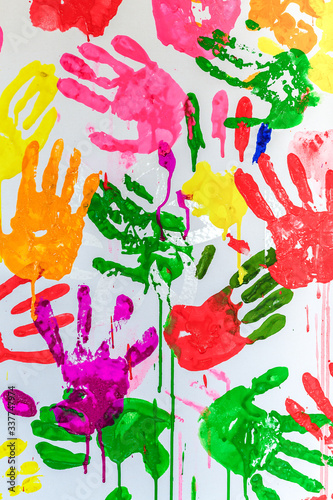 Colorful painted hand prints on white background