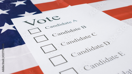 Voting for Presidential elections 2020 with ballot on American flag.