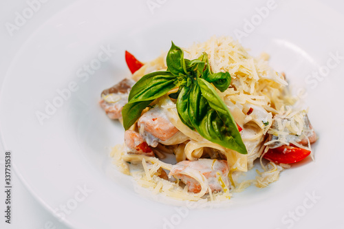 fettuccine pasta with red tomato fish and cheese
