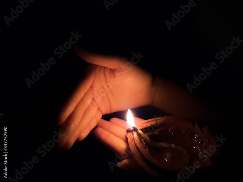 Canvas Print Diwali festival of lights, hand lighting an indian oil lamp