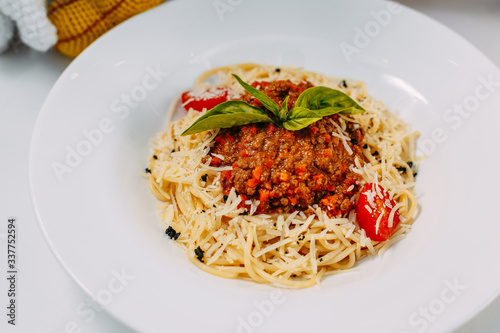 italian pasta bolognese with tomatoes and basil isolated on white background