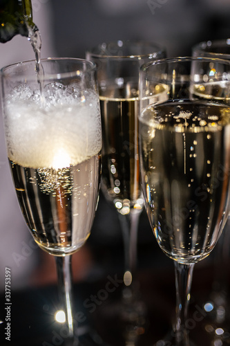 Glasses with champagne close-up. Champagne is poured into a glass