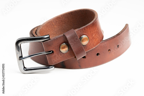 A formal studio product shot of a men’s used brown leather belt with patina set on plain white background.